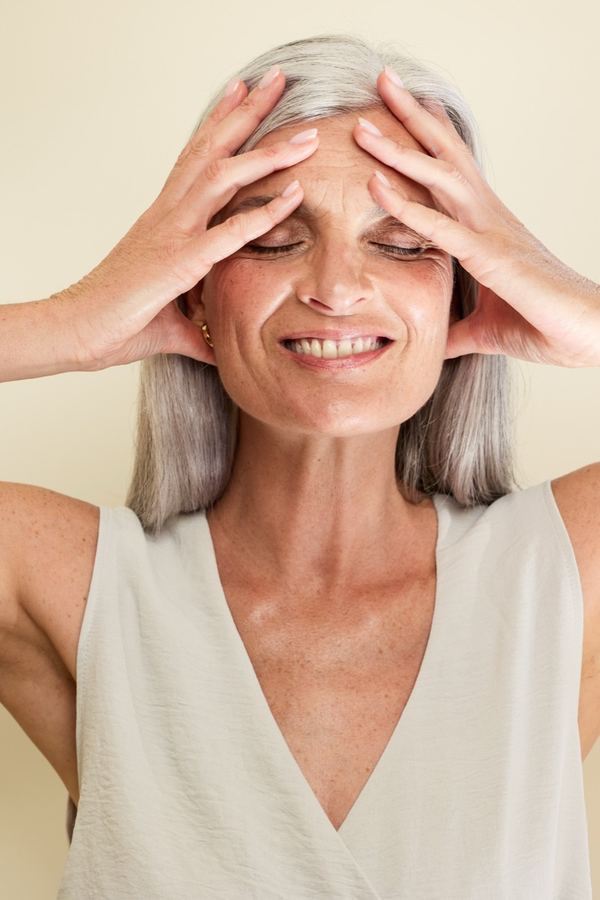 Frau im weißen Top, entspannt lächelnd